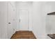 Bright entryway with wood-look floors, white walls, and built-in shelving at 128 Mooring Dr, Statesville, NC 28677