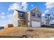 Two-story house with gray siding, attached garage, and landscaping at 128 Mooring Dr, Statesville, NC 28677