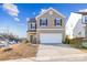 Two-story house with neutral siding, attached garage, and landscaping at 128 Mooring Dr, Statesville, NC 28677