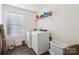 Laundry room with washer, dryer and shelving at 128 Mooring Dr, Statesville, NC 28677