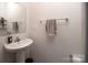 Small bathroom with pedestal sink and mirror at 131 Crownpiece St, Troutman, NC 28166