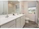 Main bathroom with double vanity, shower, and vinyl plank flooring at 131 Crownpiece St, Troutman, NC 28166