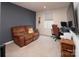 Versatile bonus room with leather couch and home office setup at 131 Crownpiece St, Troutman, NC 28166