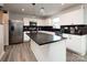 Modern kitchen with white cabinets, stainless steel appliances, and dark countertops at 131 Crownpiece St, Troutman, NC 28166