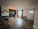 Open-concept living room boasts wood-look flooring, a chalkboard wall, and plenty of natural light at 131 Crownpiece St, Troutman, NC 28166