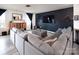 Living room with sectional sofa and a black accent wall at 131 Crownpiece St, Troutman, NC 28166