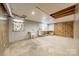 Partially finished basement with utility sink, water heater, wood paneled walls, and window at 1486 Amity Church Rd, Denver, NC 28037