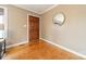 Entryway featuring wood flooring, natural-toned walls, and a door with a round mirror at 1486 Amity Church Rd, Denver, NC 28037