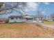 Charming single-story home with light blue siding and a red trimmed porch and shutters at 1486 Amity Church Rd, Denver, NC 28037