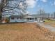 Charming single-story home with light blue siding and a red trimmed porch and shutters at 1486 Amity Church Rd, Denver, NC 28037