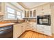 Close-up of the kitchen area with black sink, black dishwasher, mosaic tile backsplash, and butcher block countertops at 1486 Amity Church Rd, Denver, NC 28037