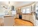 Bright kitchen featuring a stainless steel hood, butcher block countertops, black dishwasher, and hardwood floors at 1486 Amity Church Rd, Denver, NC 28037