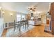 Bright kitchen with a center island, stainless steel hood, white cabinets, and hardwood floors at 1486 Amity Church Rd, Denver, NC 28037