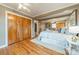 Spacious main bedroom boasts hardwood floors and a generously sized closet, offering ample storage at 1486 Amity Church Rd, Denver, NC 28037