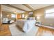 A main bedroom with a queen bed, wood floors, and exposed beams creates a cozy and inviting space at 1486 Amity Church Rd, Denver, NC 28037