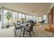 Sunroom features a glass top table and chairs on a patterned rug, surrounded by floor-to-ceiling windows at 1486 Amity Church Rd, Denver, NC 28037