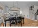 Bright dining area with dark wood table and hardwood floors at 15409 Brem Ln, Charlotte, NC 28277