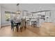 Kitchen and dining area with hardwood floors and modern lighting at 15409 Brem Ln, Charlotte, NC 28277