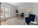 Home office with a large window, built-in desk and blue chair at 15409 Brem Ln, Charlotte, NC 28277