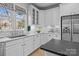 White kitchen with stainless steel appliances and marble countertops at 15409 Brem Ln, Charlotte, NC 28277