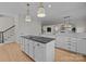 Large kitchen island with dark countertop and cooktop at 15409 Brem Ln, Charlotte, NC 28277