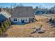 Backyard aerial view showing home, fire pit, and landscaping at 16303 Cozy Cove Rd, Charlotte, NC 28278