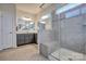 Bathroom with double vanity, large shower, and gray tile at 16303 Cozy Cove Rd, Charlotte, NC 28278