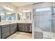 Elegant bathroom with double vanity, large mirror, and walk-in shower at 16303 Cozy Cove Rd, Charlotte, NC 28278