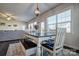 Farmhouse style dining table with bench seating in bright dining area at 16303 Cozy Cove Rd, Charlotte, NC 28278