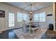 Bright dining area with farmhouse table, bench, and access to backyard at 16303 Cozy Cove Rd, Charlotte, NC 28278