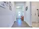 Inviting entryway with hardwood floors and a wooden bench at 16303 Cozy Cove Rd, Charlotte, NC 28278