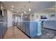 Spacious kitchen island with white quartz countertop and gray cabinets at 16303 Cozy Cove Rd, Charlotte, NC 28278