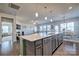 Open kitchen with island, stainless steel appliances, and hardwood floors at 16303 Cozy Cove Rd, Charlotte, NC 28278