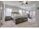 Spacious main bedroom with large bed, access to private deck, and en-suite bathroom at 16303 Cozy Cove Rd, Charlotte, NC 28278