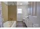 Full bathroom with tub and shower, and gray tile at 1691 Montevista Dr, Shelby, NC 28150