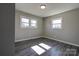 Well-lit bedroom featuring wood-look floors and two windows at 1691 Montevista Dr, Shelby, NC 28150