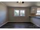 Dining area with wood-look floors and view into kitchen at 1691 Montevista Dr, Shelby, NC 28150