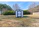 White shed with black trim in grassy backyard at 1691 Montevista Dr, Shelby, NC 28150