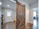 Inviting entryway with a rustic barn door and built-in bench at 17 Walnut St, China Grove, NC 28023