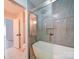 Bathroom featuring modern bathtub and glass shower at 17004 Commons Creek Dr, Charlotte, NC 28277