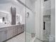 Modern bathroom featuring double sinks, granite countertops, and a frameless glass shower with eye catching tile at 17004 Commons Creek Dr, Charlotte, NC 28277