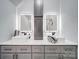 Bathroom with double sinks, quartz countertops, modern cabinets, and framed mirrors with integrated lighting at 17004 Commons Creek Dr, Charlotte, NC 28277