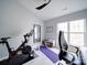 Bedroom featuring exercise bike, ceiling fan, and bright window at 17004 Commons Creek Dr, Charlotte, NC 28277