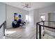 Open loft space with sleek railings, fan, furniture and bright natural light at 17004 Commons Creek Dr, Charlotte, NC 28277