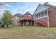 Expansive brick home featuring a two-level deck and screened in porch, perfect for outdoor living at 1915 Cavendale Dr, Rock Hill, SC 29732