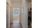 Hallway leading to a primary bathroom suite featuring a large soaking tub with natural light at 1915 Cavendale Dr, Rock Hill, SC 29732