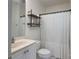 Small bathroom featuring a stand-alone sink, toilet, shower with curtain, and decorative shelving unit at 1915 Cavendale Dr, Rock Hill, SC 29732