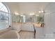 Bright bathroom featuring a soaking tub, double vanity, large mirror, and ample natural light from an arched window at 1915 Cavendale Dr, Rock Hill, SC 29732