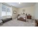 Warm bedroom with a four-poster bed, soft carpet, and bench with a view of the exterior at 1915 Cavendale Dr, Rock Hill, SC 29732