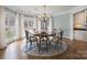 Elegant dining room with large windows, a chandelier, and ample seating for formal gatherings at 1915 Cavendale Dr, Rock Hill, SC 29732